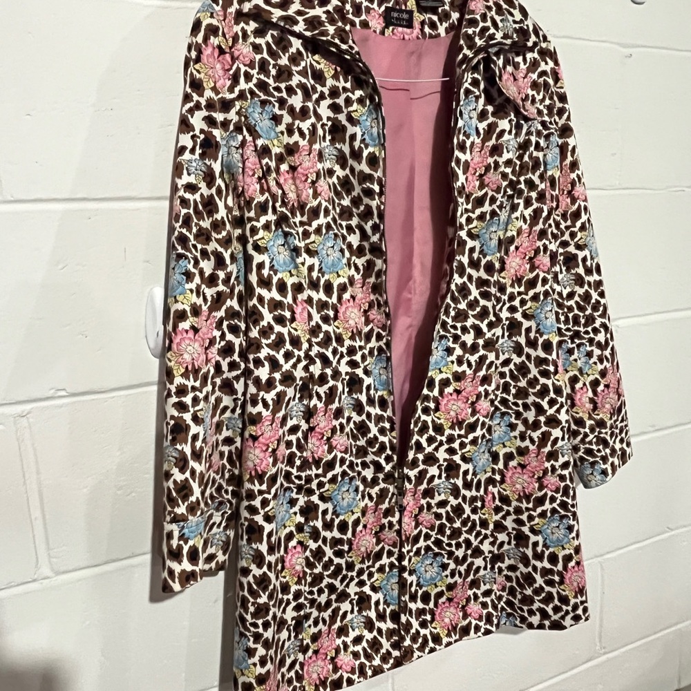 Rain coat with a floral print and it looks good with a dress or jeans